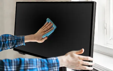 Man using a cloth to wipe a ViewSonic monitor screen